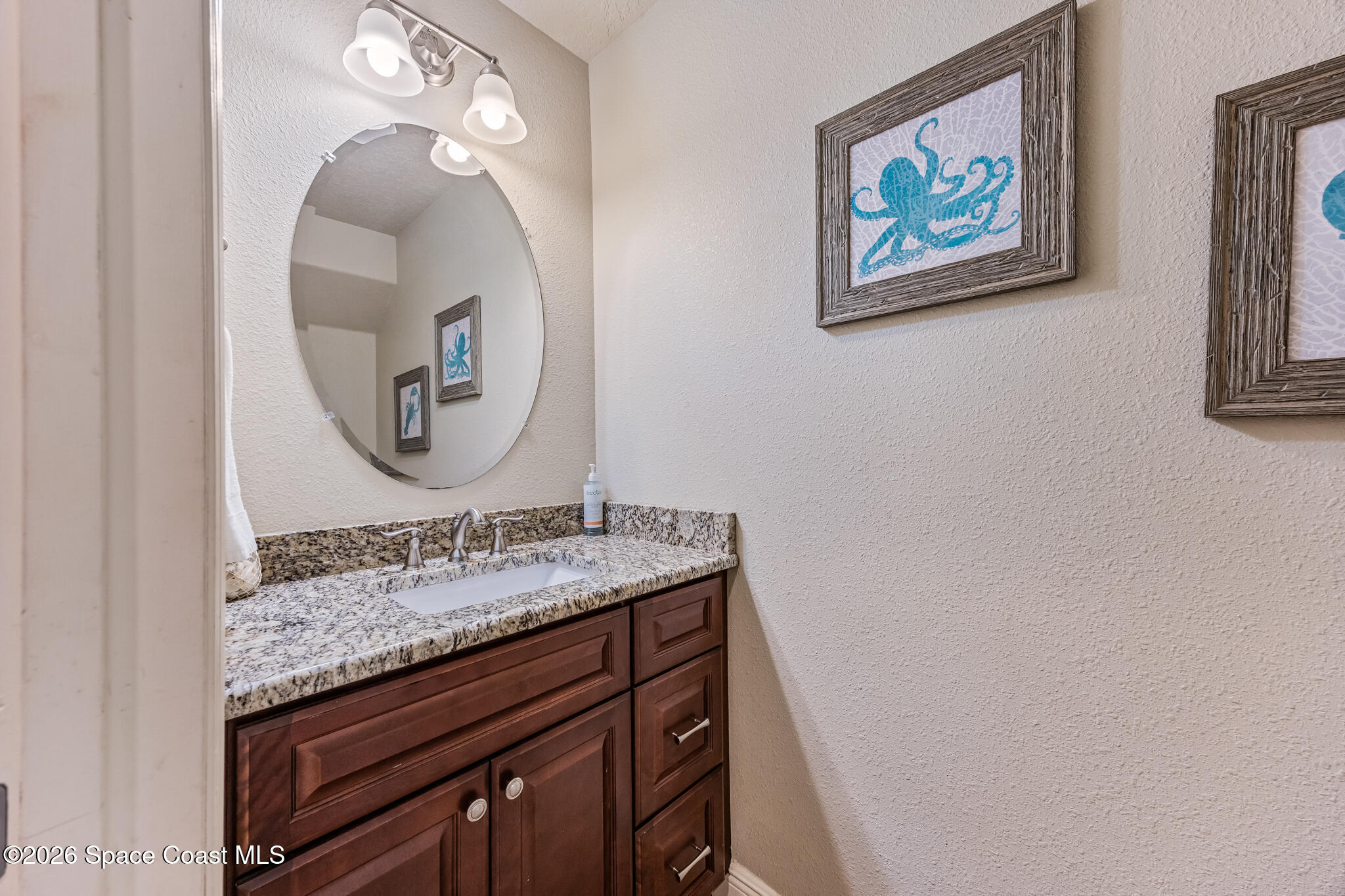 2709 Cutlass Point Lane, Unit 102 Merritt Island, FL 32953 - Photo 8 of 37 a bathroom with a granite countertop sink mirror and vanity