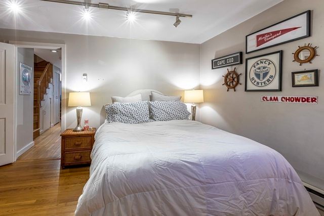 a bedroom with a bed and a lamp on table