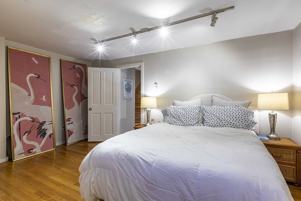 54 Appleton Street, Unit 1 Boston, MA 02116 - Photo 16 of 28 a bedroom with a large bed and a painting on the wall