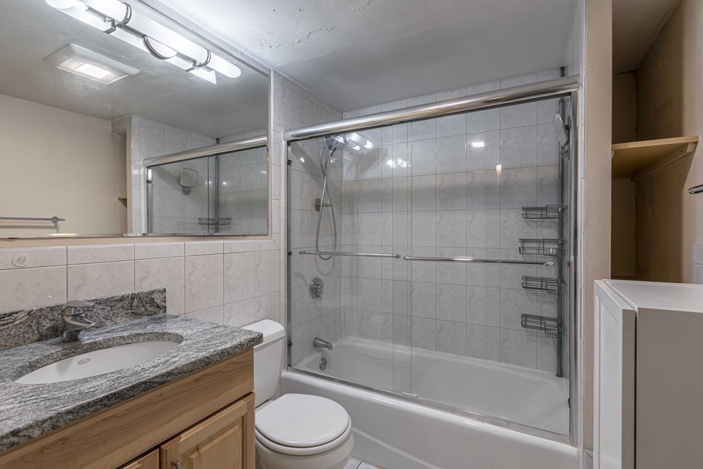 54 Appleton Street, Unit 1 Boston, MA 02116 - Photo 19 of 28 a bathroom with a granite countertop sink toilet and shower