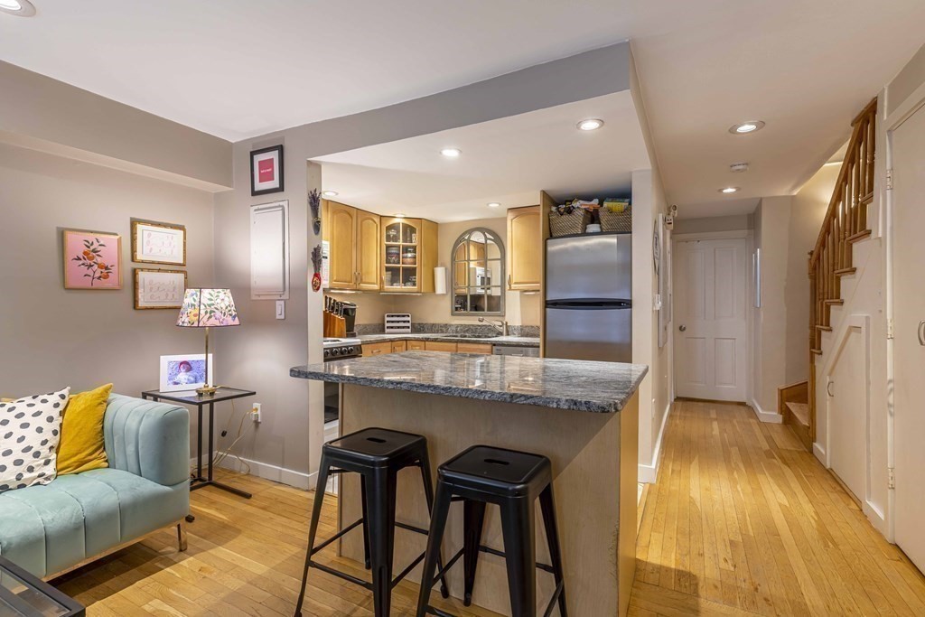 54 Appleton Street, Unit 1 Boston, MA 02116 - Photo 5 of 28 a kitchen with granite countertop kitchen island stainless steel appliances a sink and counter space