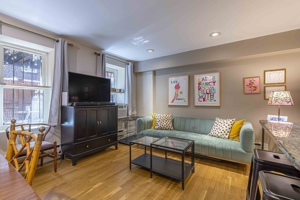 54 Appleton Street, Unit 1 Boston, MA 02116 - Photo 6 of 28 a living room with furniture and a flat screen tv