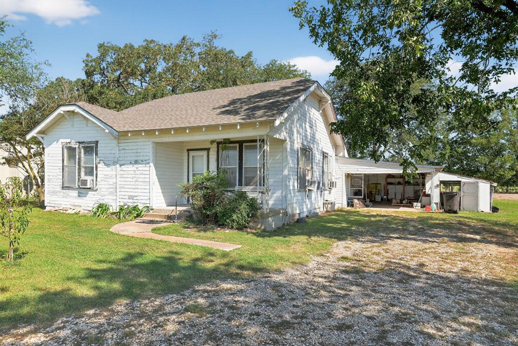 5485 Highway 7 Marlin, TX 76661 - Photo 28 of 36 View of property exterior featuring a shingled roof, a lawn, a patio, and an outbuilding