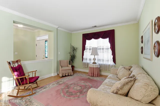 a living room with furniture a chandelier and a table