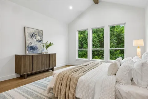 a bedroom with a bed and a painting on the wall