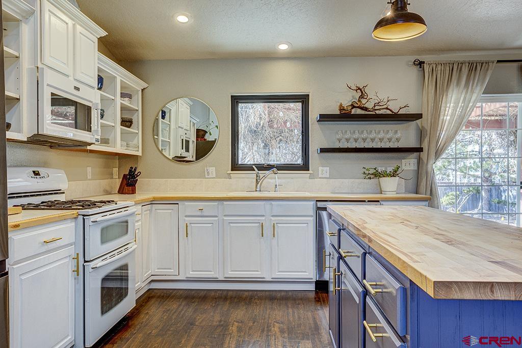 407 Colorado Street Cortez, CO 81321 - Photo 11 of 35 a kitchen with cabinets and window