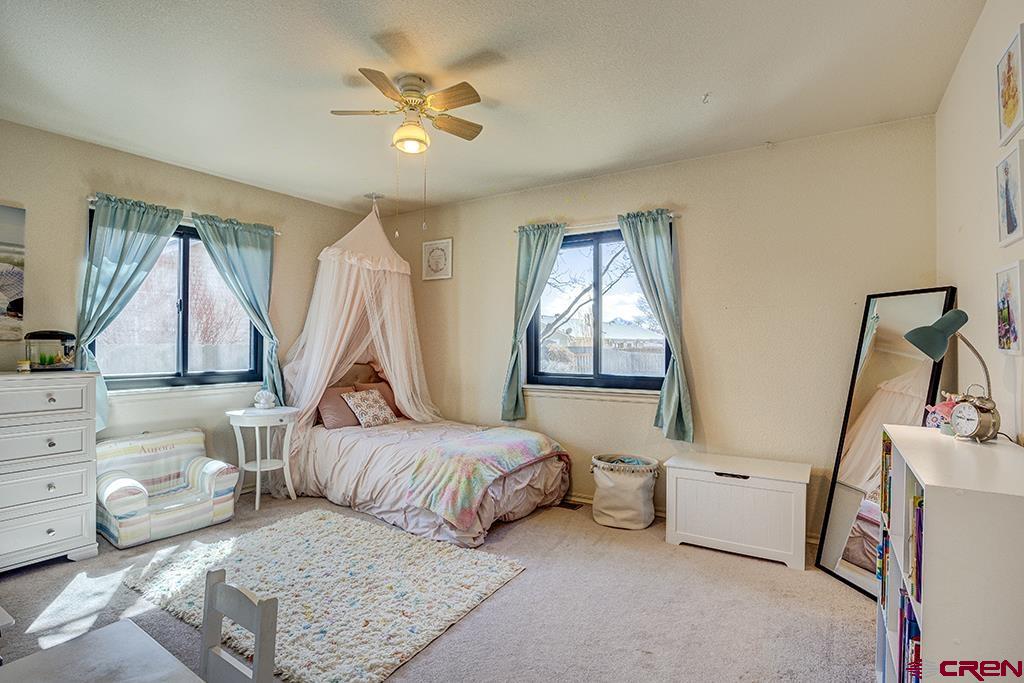407 Colorado Street Cortez, CO 81321 - Photo 23 of 35 a bedroom with a bed and a window