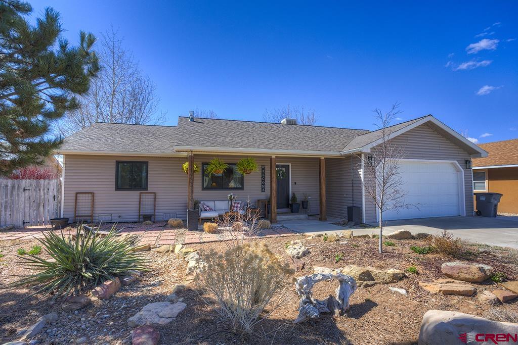 407 Colorado Street Cortez, CO 81321 - Photo 3 of 35 a front view of a house with a outdoor space