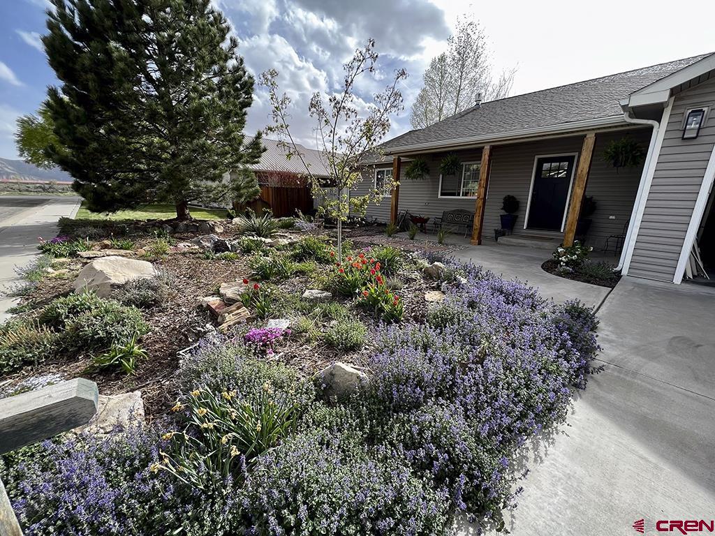 407 Colorado Street Cortez, CO 81321 - Photo 5 of 35 a view of a house with a yard and garden