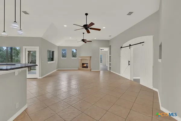 a view of a livingroom with a ceiling fan and window