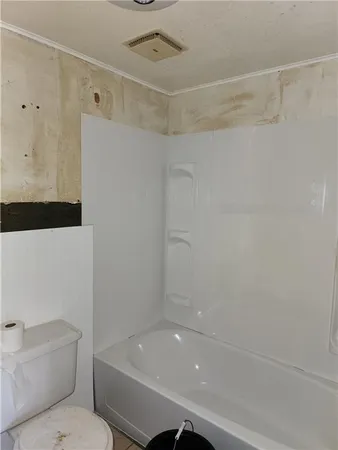 a bathroom with a bathtub and a toilet