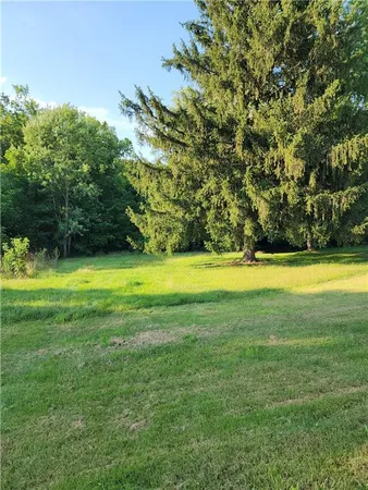 a view of a swimming pool and a yard