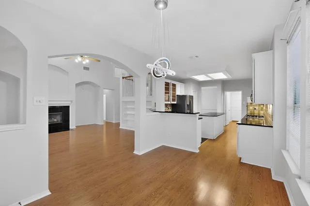 a view of a kitchen with sink and wooden floor
