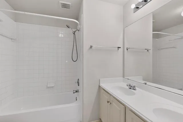 a bathroom with a sink a large mirror and a shower