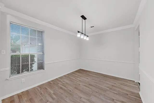 an empty room with a empty space and windows