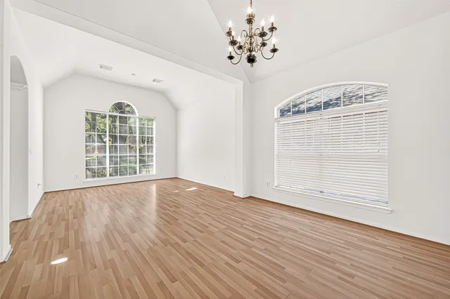 a view of a room with wooden floor