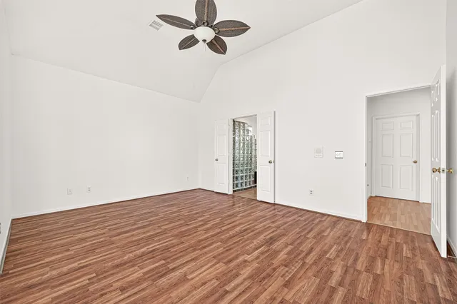 a view of a yard in front of a house with a large tree