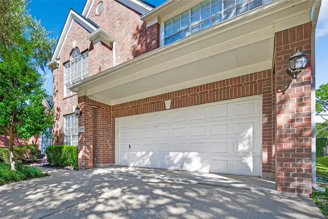 an empty room with a window and a ceiling fan