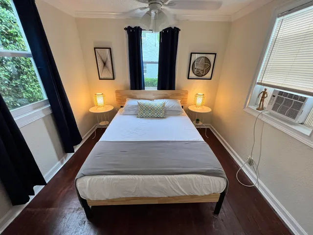a bedroom with bed and a window