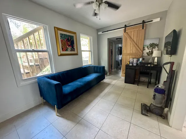 a living room with furniture and a flat screen tv