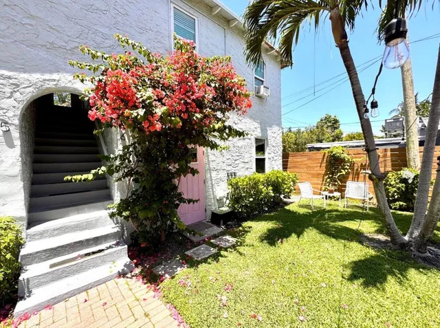 a view of a swimming pool with a chair and palm trees