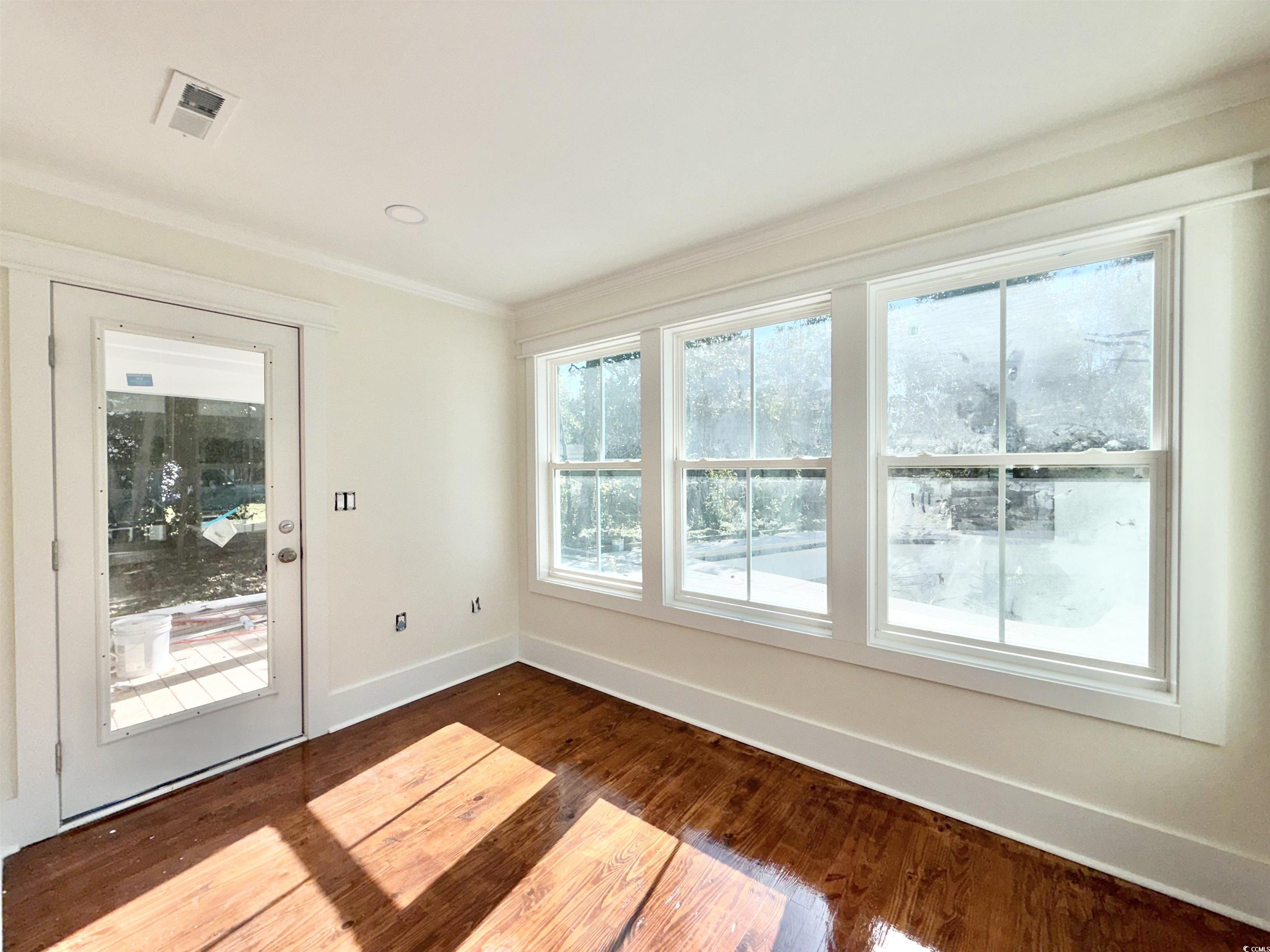 1003 Winding Road Conway, SC 29526 - Photo 14 of 32 Empty room with ornamental molding and dark wood-style floors