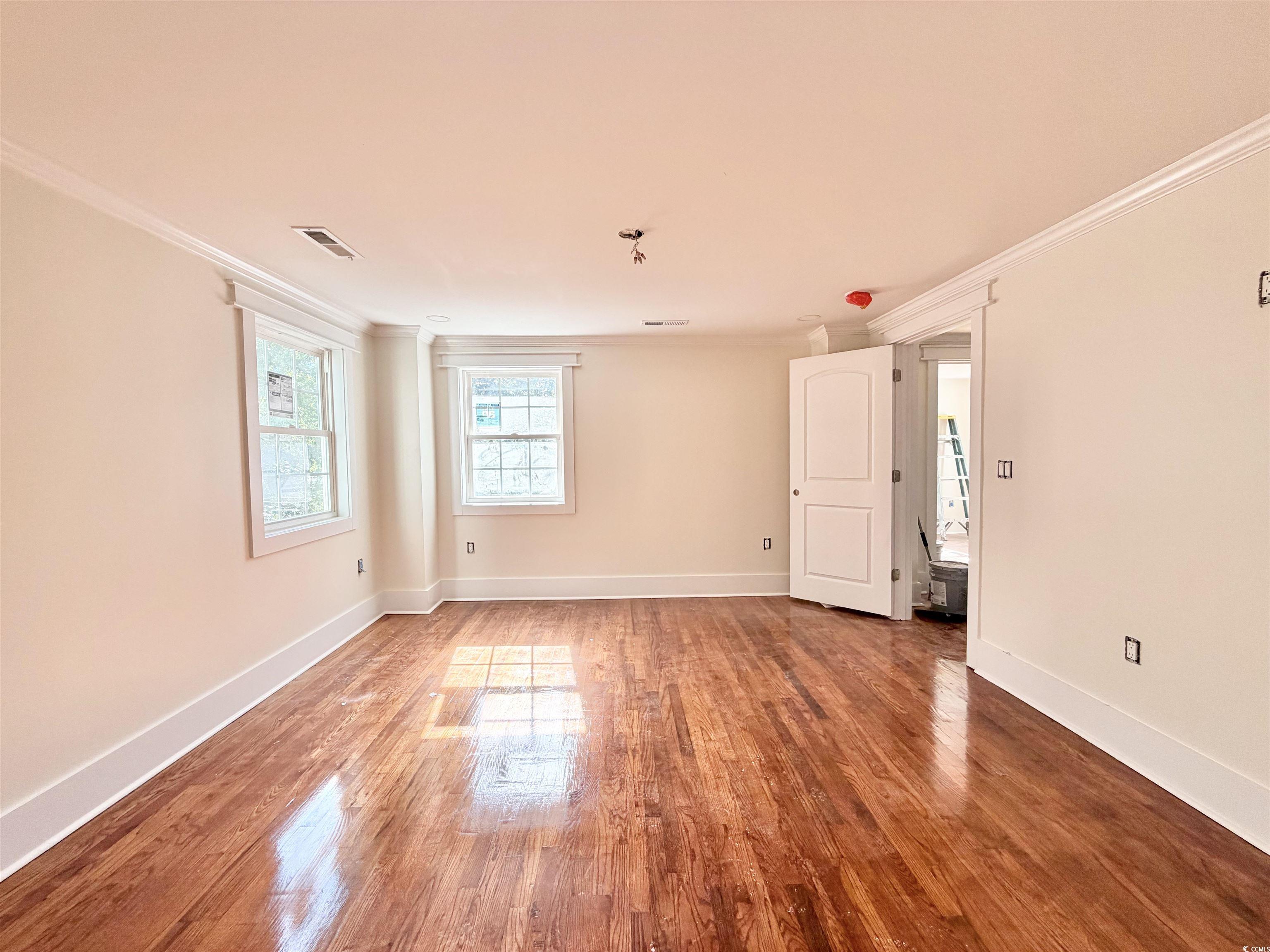 1003 Winding Road Conway, SC 29526 - Photo 19 of 32 Spare room with crown molding and wood finished floors