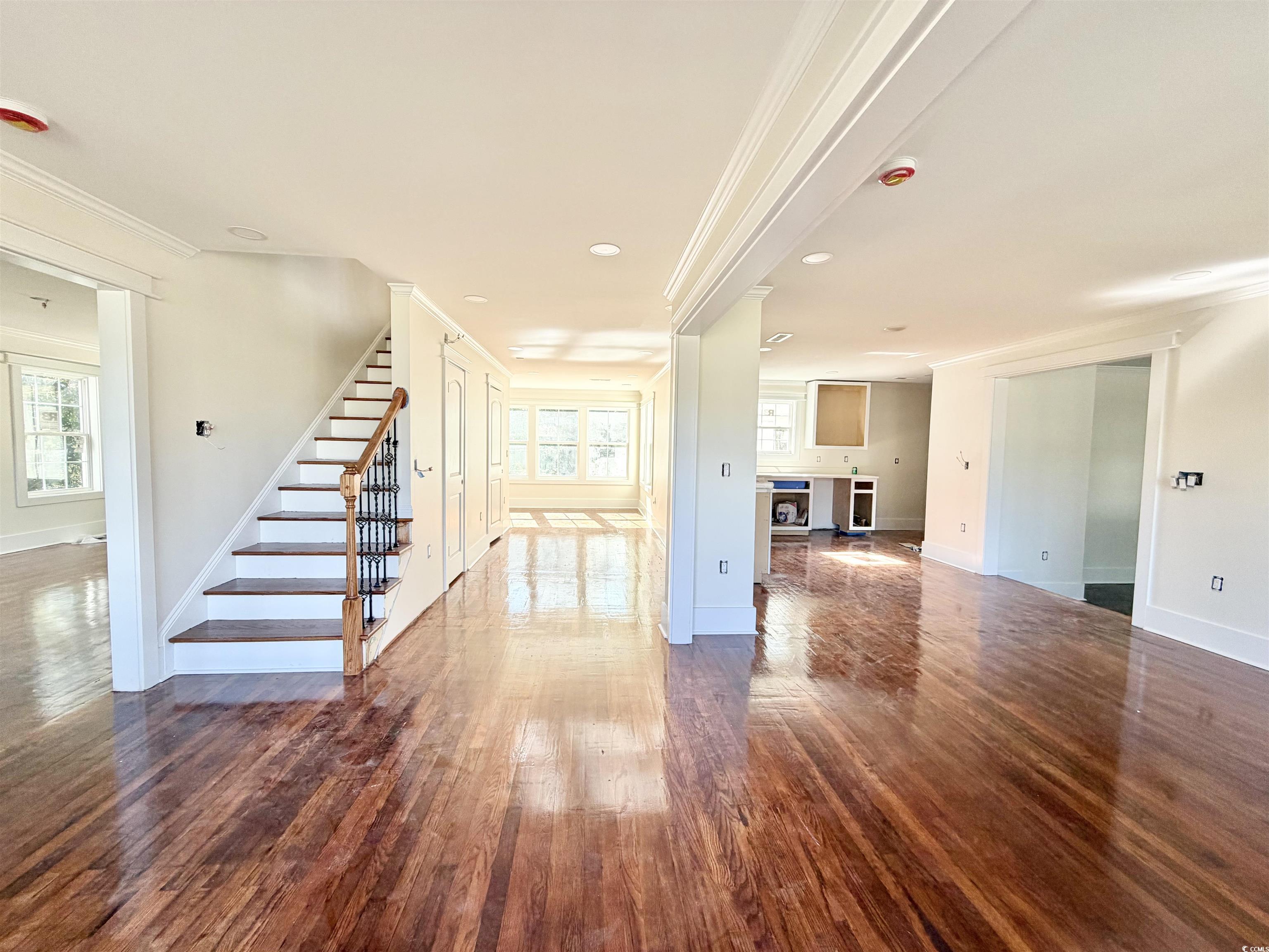 1003 Winding Road Conway, SC 29526 - Photo 2 of 32 Unfurnished living room featuring stairs, ornamental molding, dark wood-style flooring, and recessed lighting