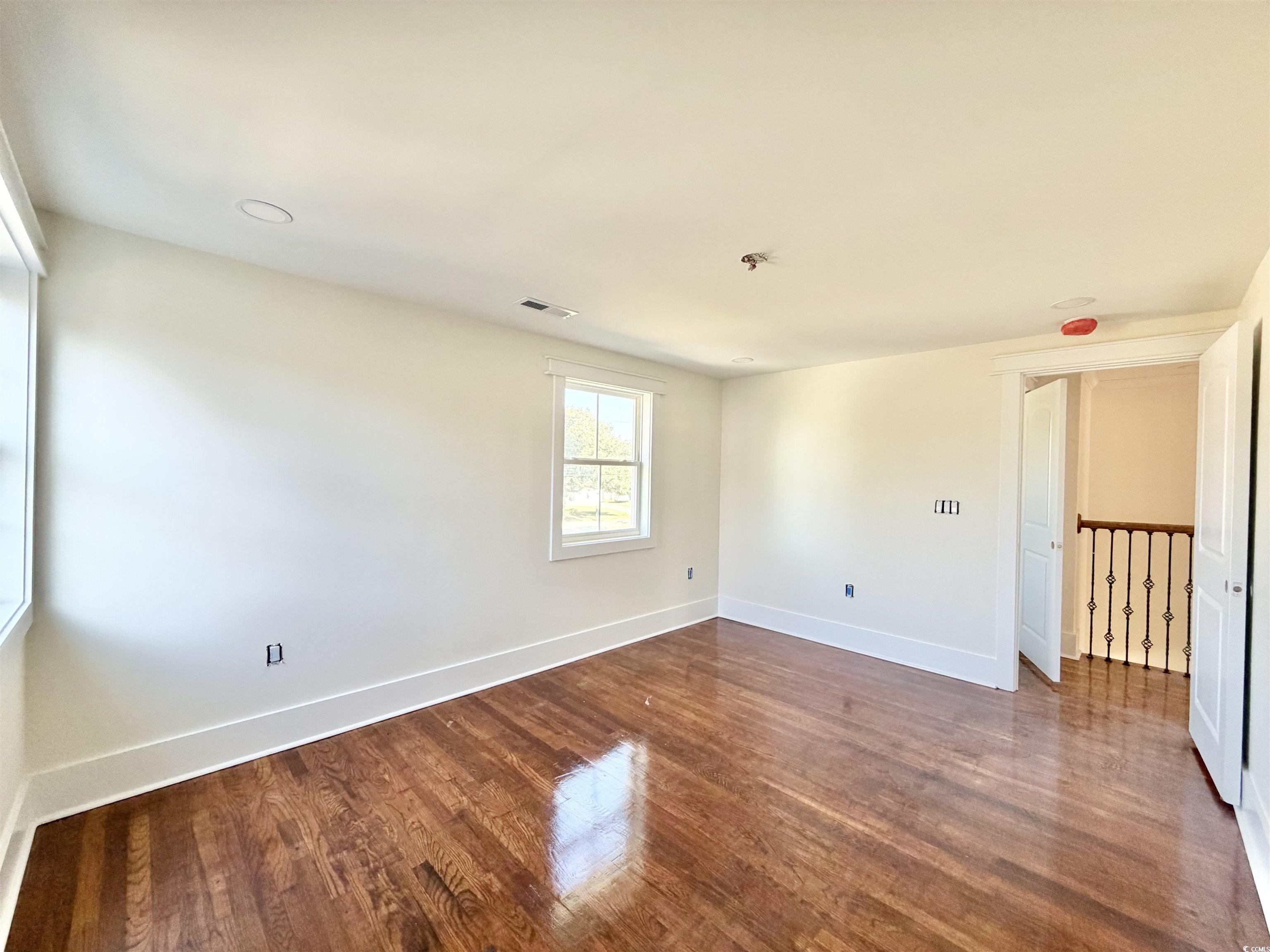 1003 Winding Road Conway, SC 29526 - Photo 27 of 32 Empty room featuring baseboards and dark wood-type flooring