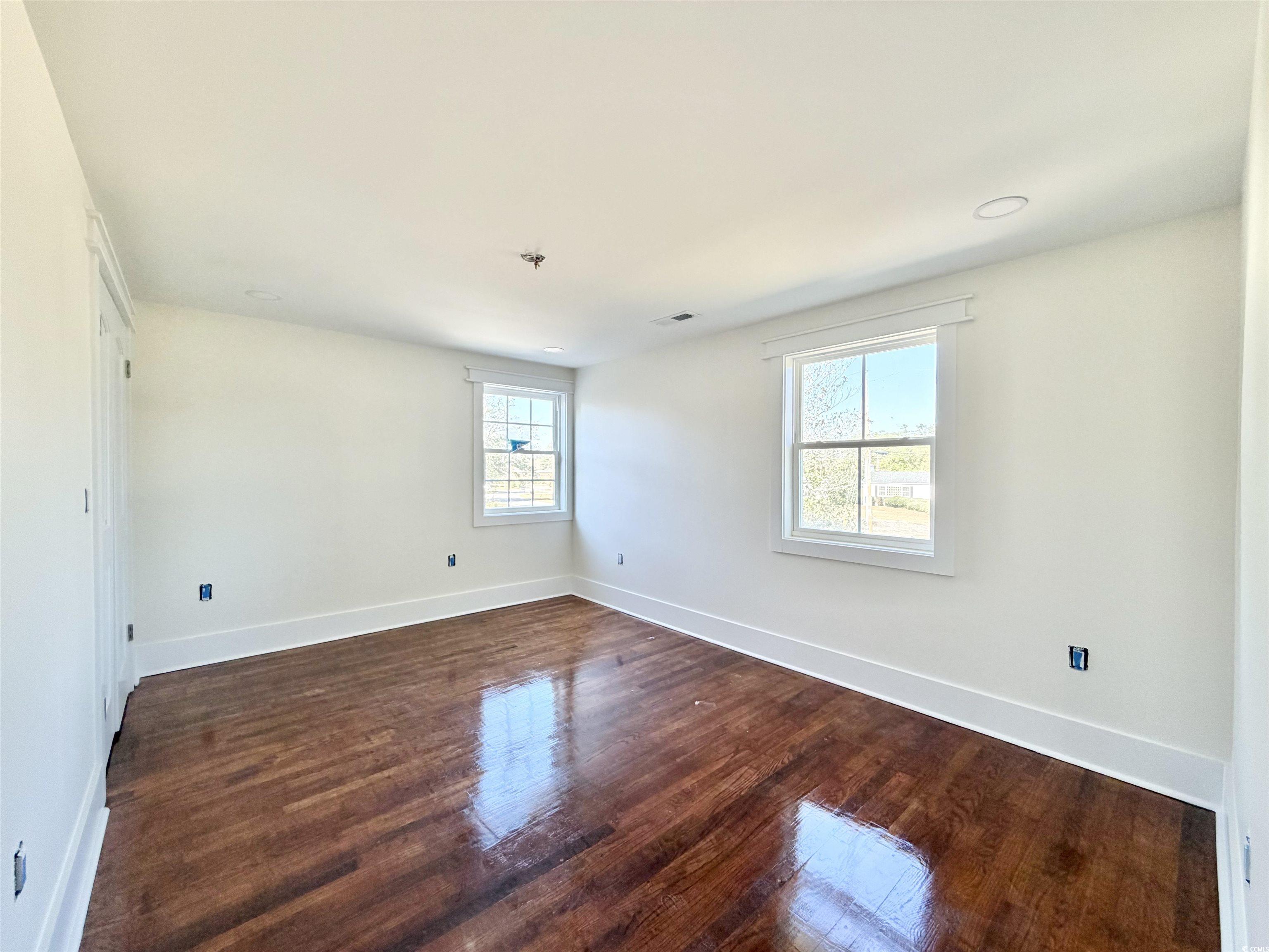 1003 Winding Road Conway, SC 29526 - Photo 28 of 32 Spare room with plenty of natural light and dark wood-style floors