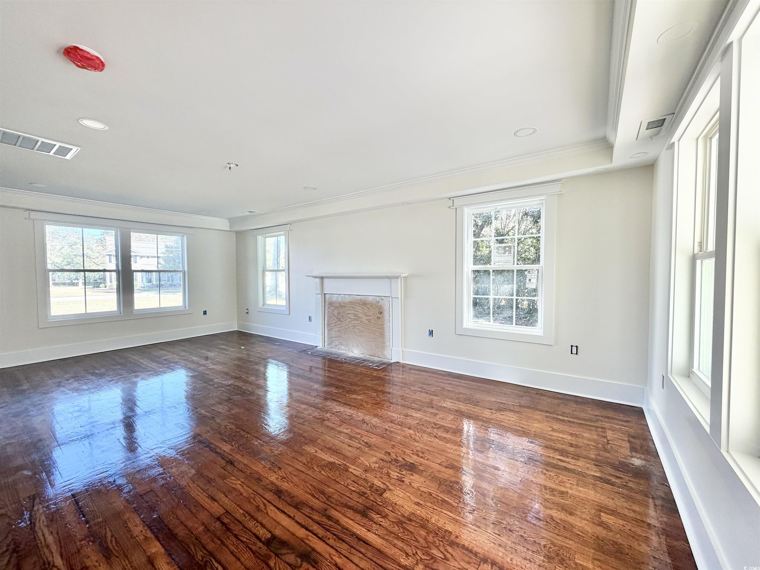 1003 Winding Road Conway, SC 29526 - Photo 5 of 32 Unfurnished living room featuring a fireplace, dark wood-type flooring, crown molding, and recessed lighting