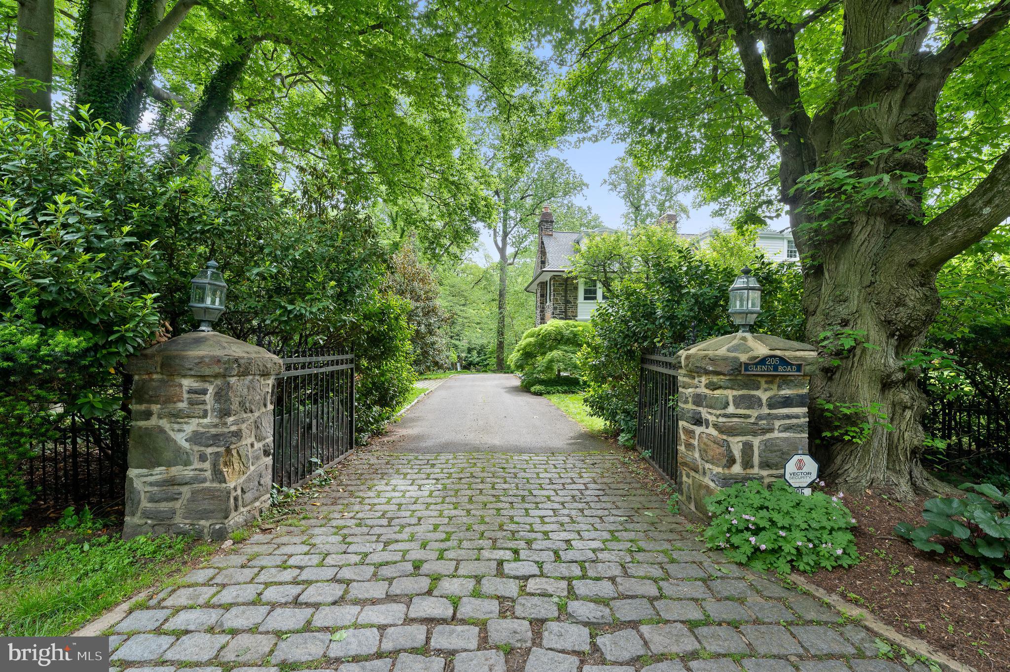 Stately Pillars, Wrought Iron Gate & Cobblestone