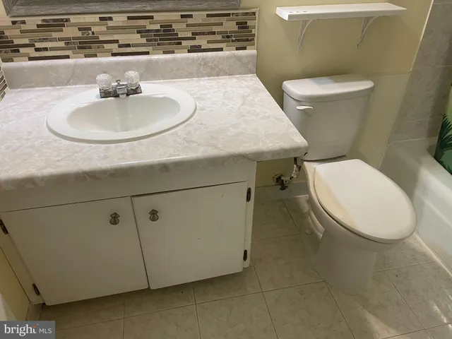 a bathroom with a sink toilet and a mirror