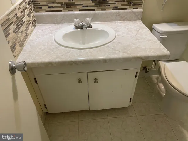 a bathroom with a sink toilet and mirror