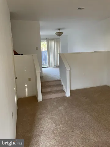 a view of an empty room with a fireplace