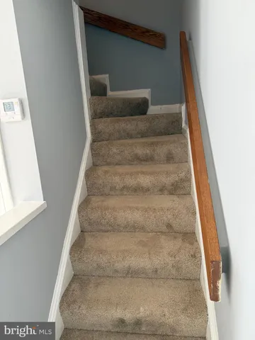 a view of staircase with white walls