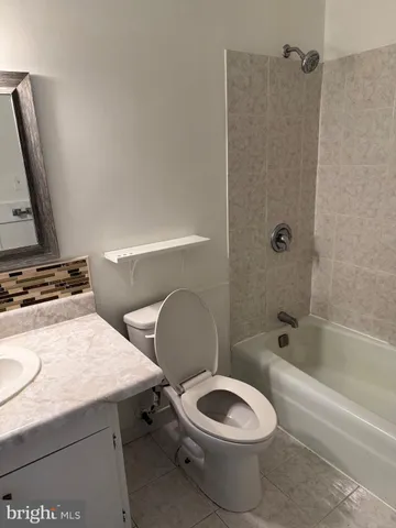 a bathroom with a sink a toilet and a bathtub
