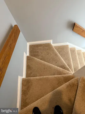 a view of staircase with white walls
