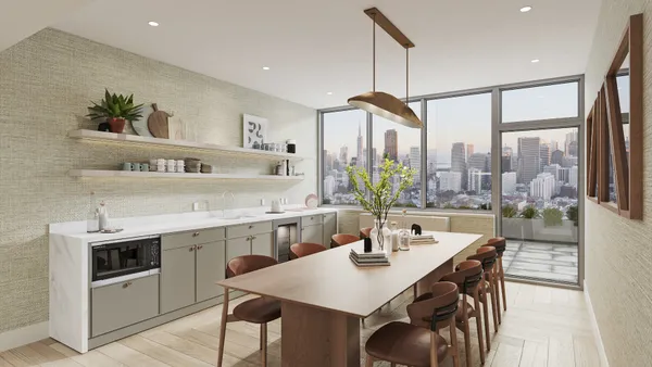 a kitchen with stainless steel appliances a table and chairs in it
