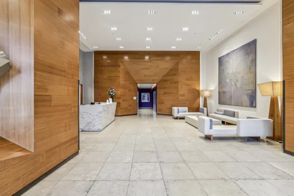 a lobby with furniture and window