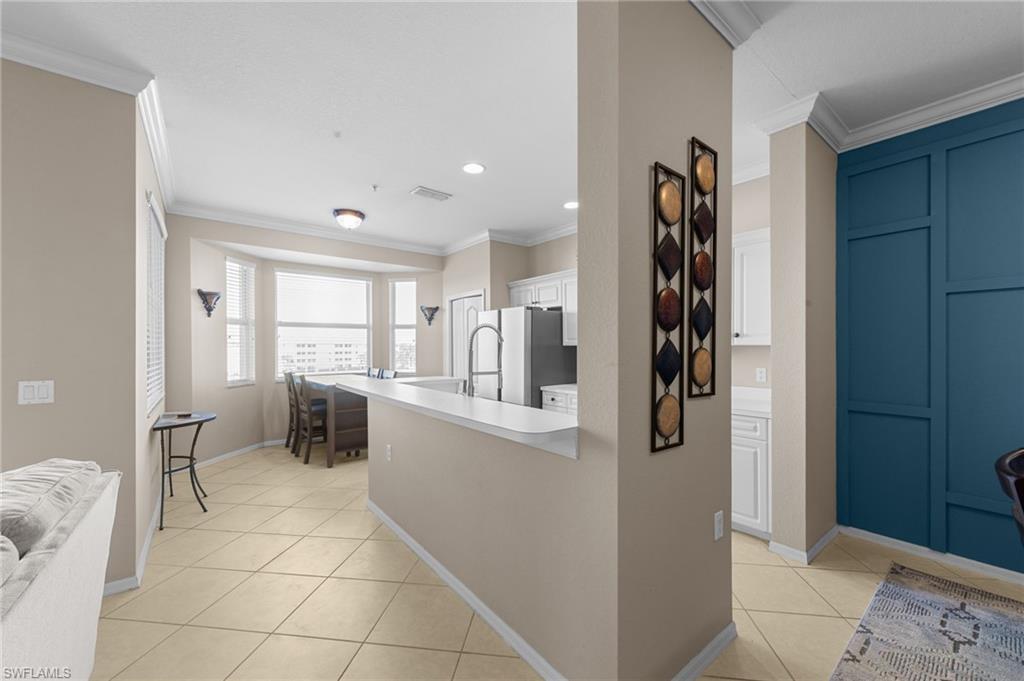 8570 Kingbird Loop, Unit 547 Estero, FL 33967 - Photo 12 of 50 a kitchen with stainless steel appliances a refrigerator and a stove top oven