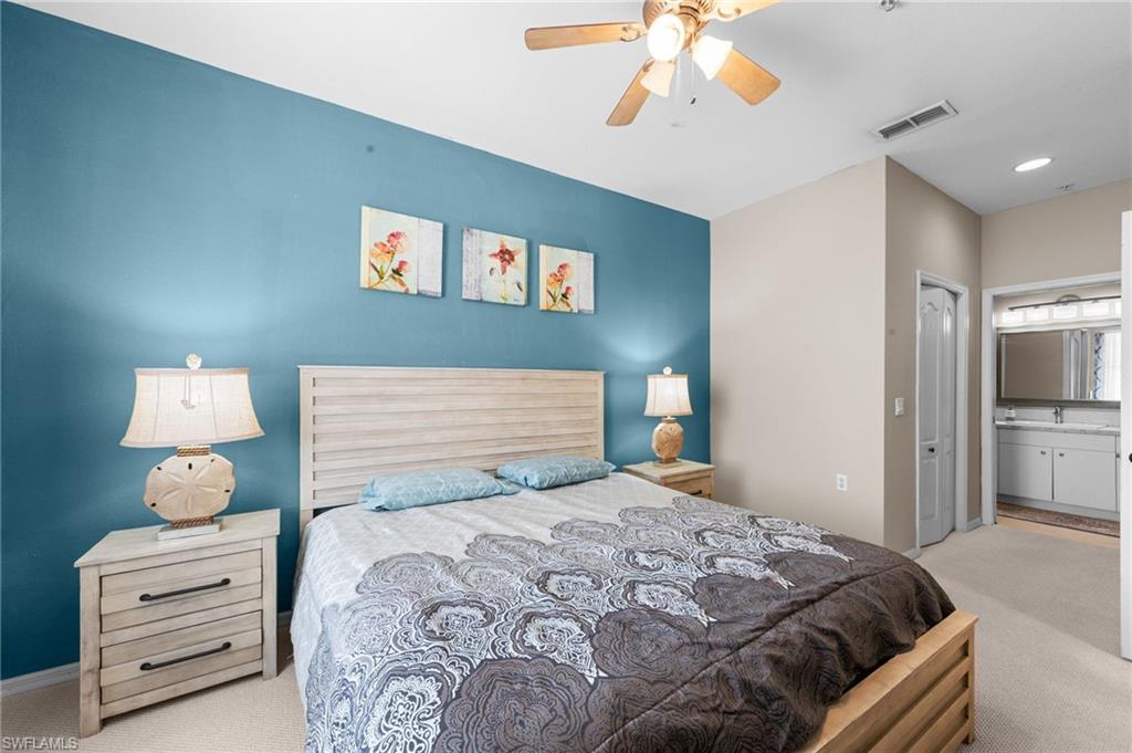 8570 Kingbird Loop, Unit 547 Estero, FL 33967 - Photo 15 of 50 a bedroom with a bed and a chandelier