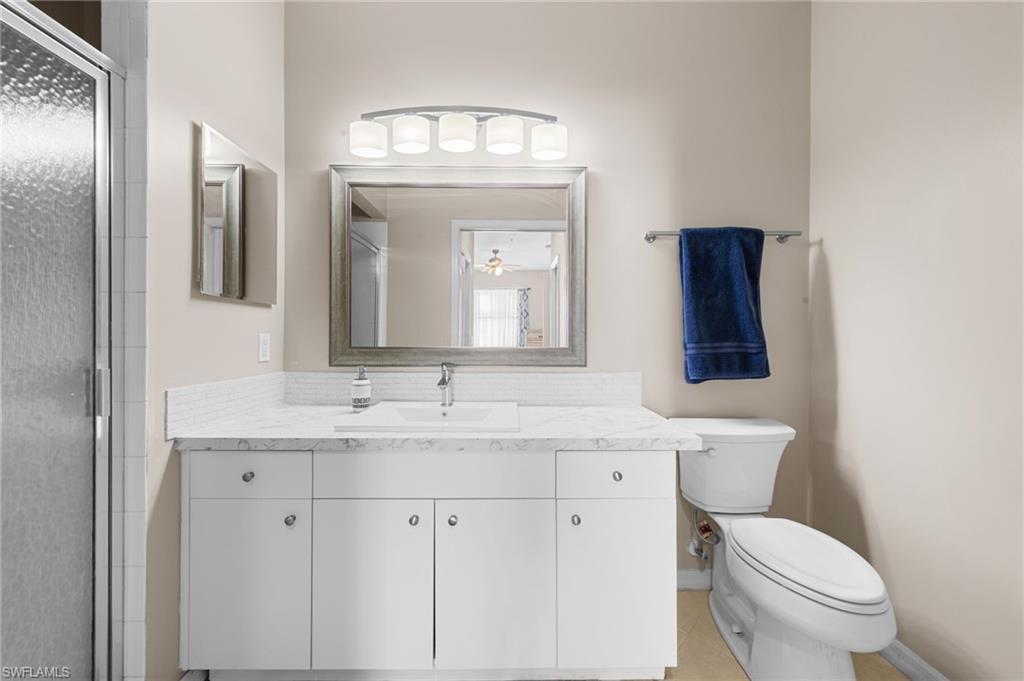 8570 Kingbird Loop, Unit 547 Estero, FL 33967 - Photo 16 of 50 a bathroom with a toilet sink and mirror