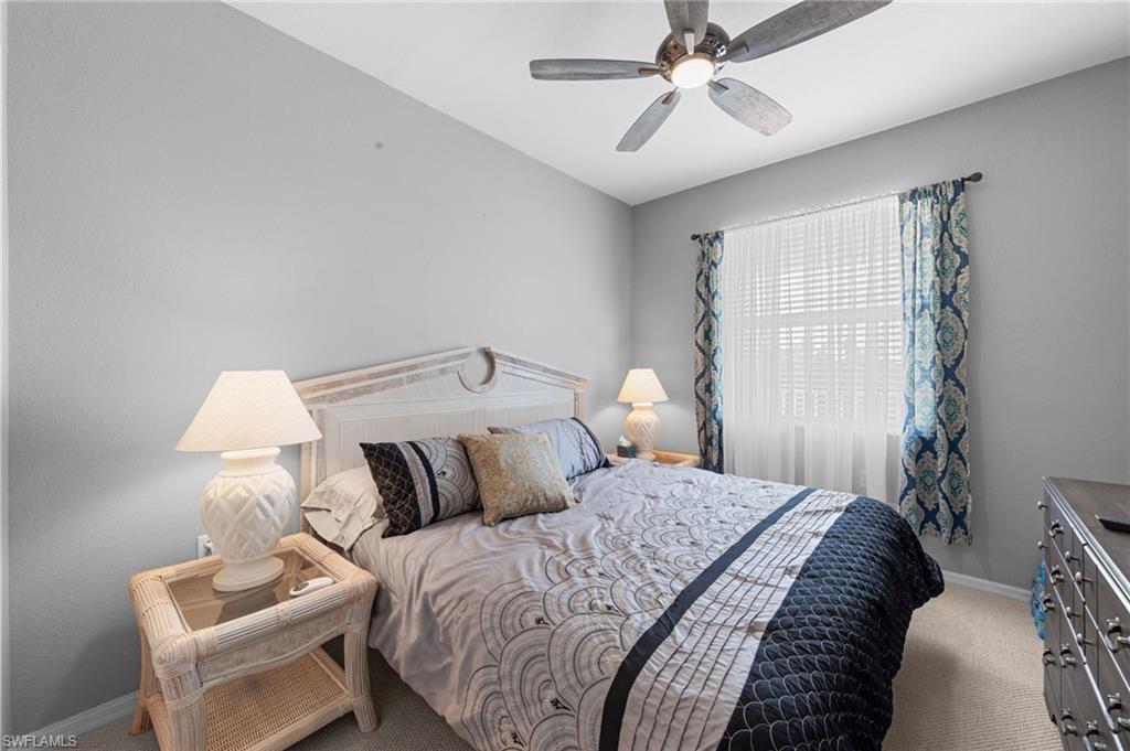8570 Kingbird Loop, Unit 547 Estero, FL 33967 - Photo 18 of 50 a bedroom with a bed and a ceiling fan