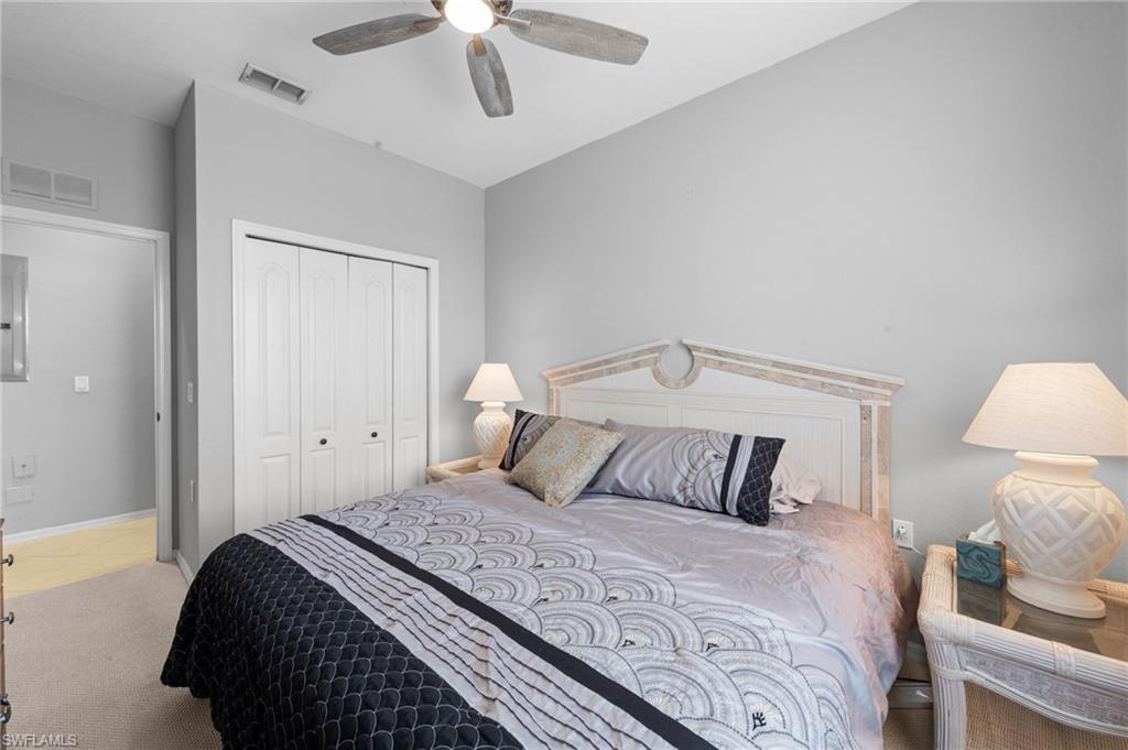 8570 Kingbird Loop, Unit 547 Estero, FL 33967 - Photo 19 of 50 a bedroom with a bed and a night stand