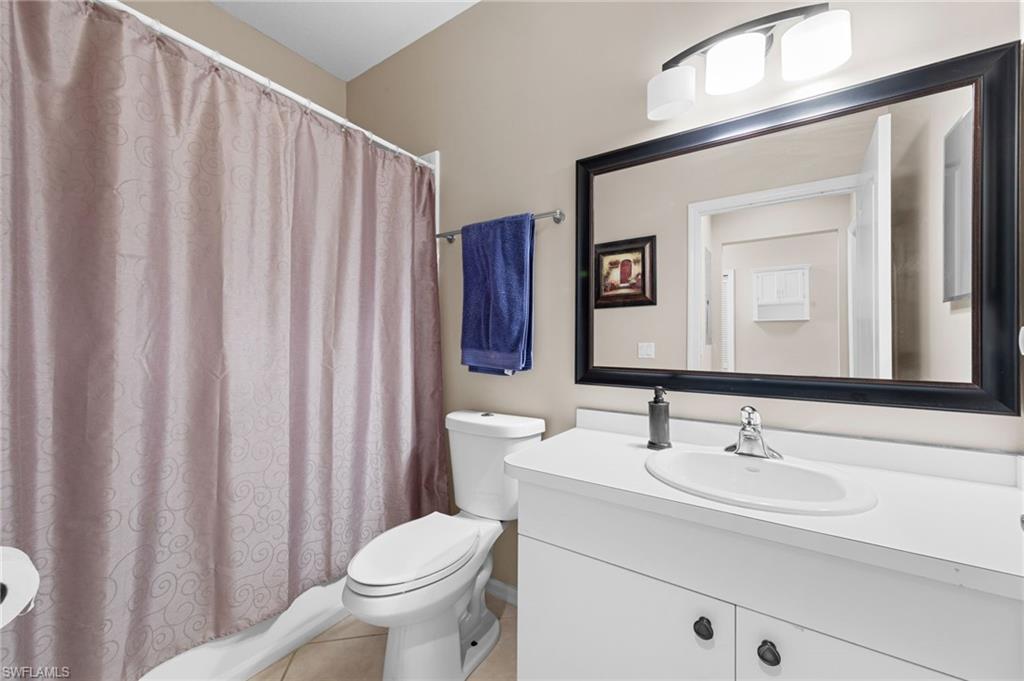 8570 Kingbird Loop, Unit 547 Estero, FL 33967 - Photo 20 of 50 a bathroom with a toilet a sink and a mirror