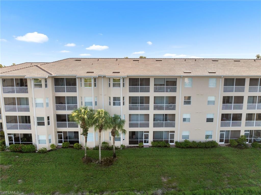 8570 Kingbird Loop, Unit 547 Estero, FL 33967 - Photo 33 of 50 front view of a building with a yard