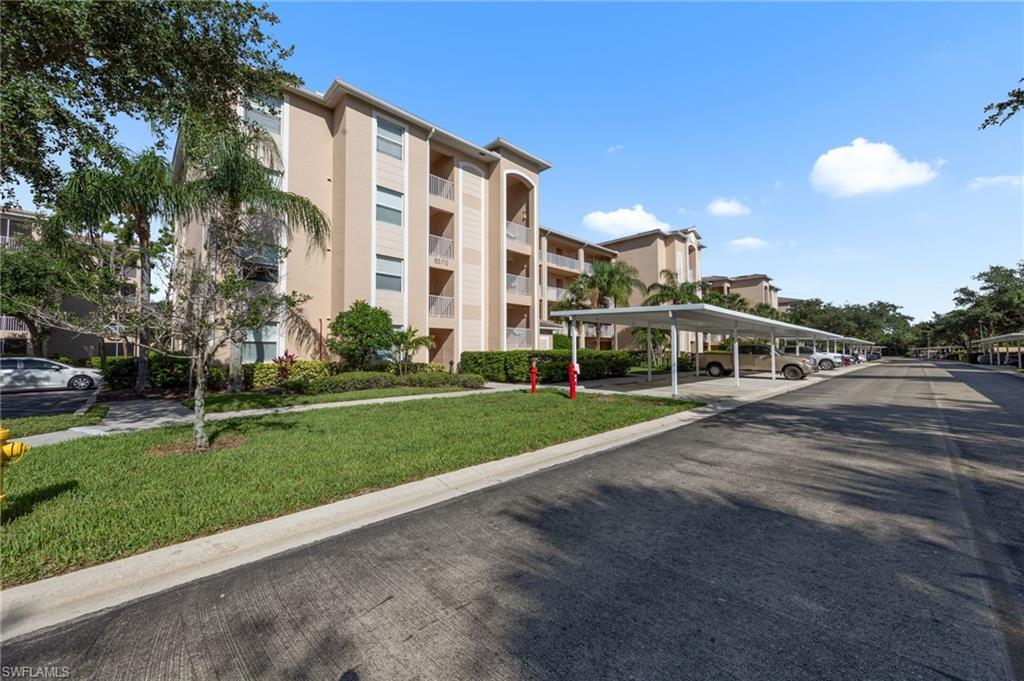 8570 Kingbird Loop, Unit 547 Estero, FL 33967 - Photo 34 of 50 a front view of a building with a garden