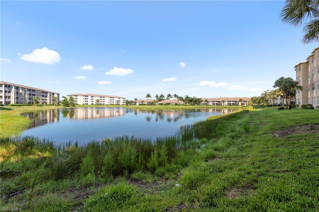 8570 Kingbird Loop, Unit 547 Estero, FL 33967 - Photo 35 of 50 a view of a lake with houses in the back