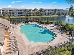 8570 Kingbird Loop, Unit 547 Estero, FL 33967 - Photo 40 of 50 a view of a lake with a yard and large trees